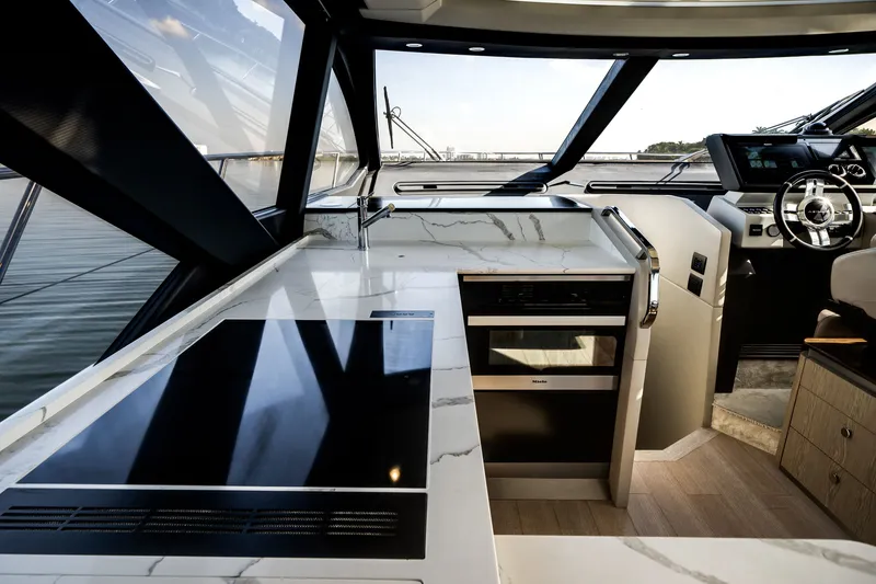 Slide: The Image of Interior of the Azimut S6 featuring a modern kitchen and helm station. - 38