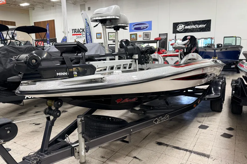 Slide: The Image of 2018 Bass Cat Lynx boat displayed indoors with Minn Kota trolling motor. - 0