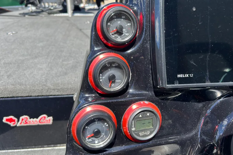 Slide: The Image of Dashboard of a 2018 Bass Cat Lynx boat with gauges and Helix 12 display. - 16