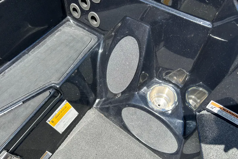 Slide: The Image of Interior of a 2018 Bass Cat Lynx boat, featuring cup holders and storage compartments. - 17