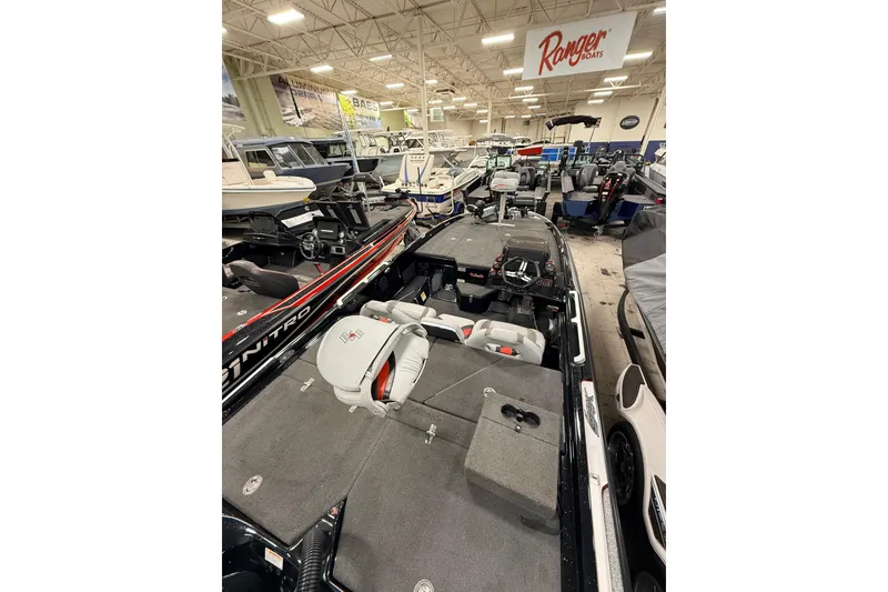 Slide: The Image of 2018 Bass Cat Lynx boat displayed in a showroom with other boats. - 2