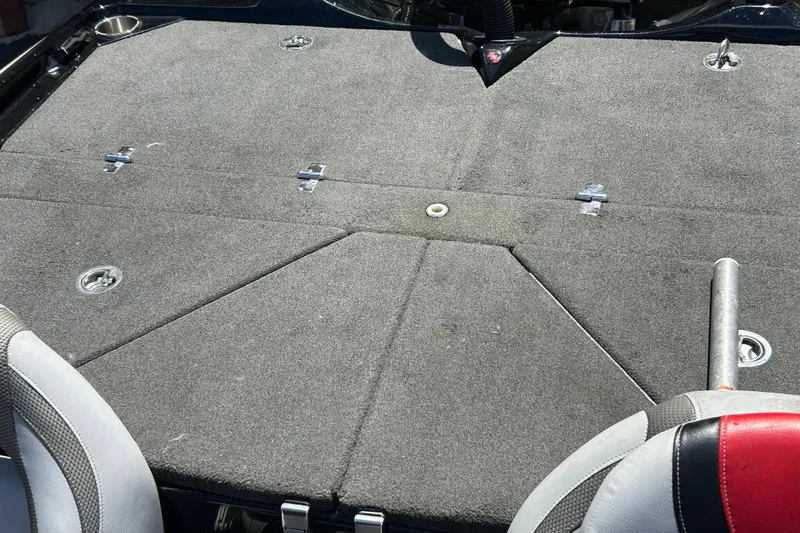 Slide: The Image of 2018 Bass Cat Lynx boat interior with carpeted deck and seating. - 20
