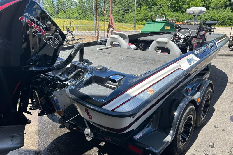 Slide: The Image of 2018 Bass Cat Lynx boat with Mercury Pro XS engine, parked outdoors. - 21