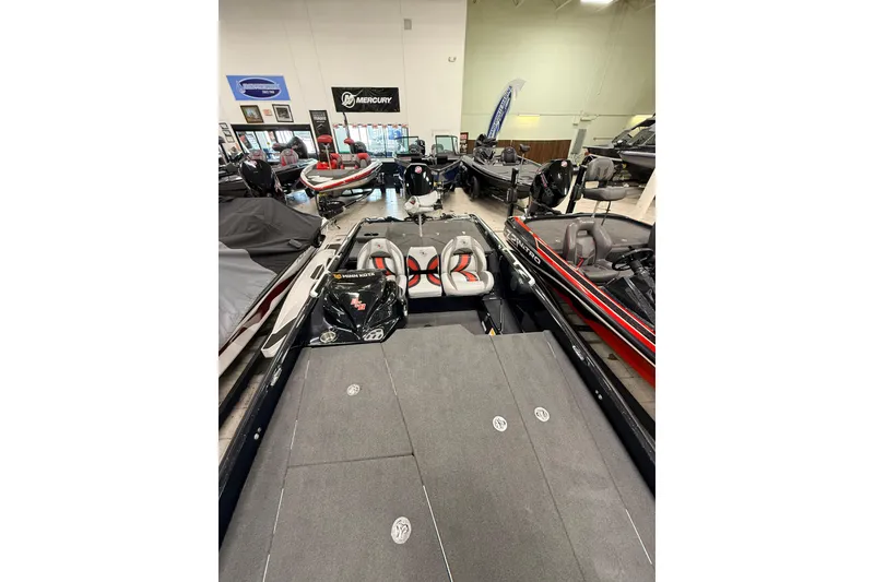 Slide: The Image of 2018 Bass Cat Lynx boat displayed in a showroom with other boats. - 3