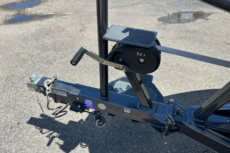 Slide: The Image of Trailer hitch and winch of a 2018 Bass Cat Lynx boat on asphalt. - 8