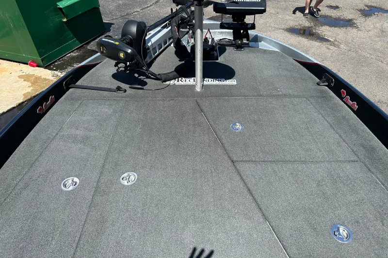 Slide: The Image of 2018 Bass Cat Lynx boat deck with fishing equipment and storage compartments. - 9