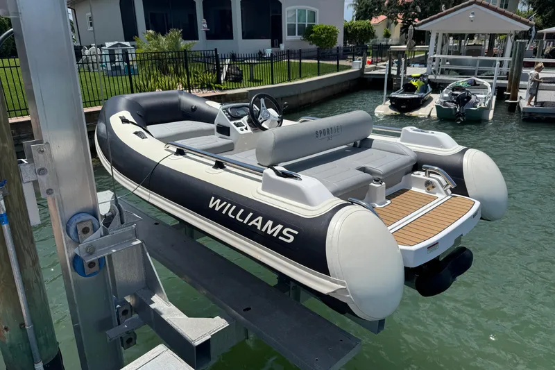 The Image of 2025 Williams Jet Tenders Sportjet 345 on lift, docked by waterfront home. - 0