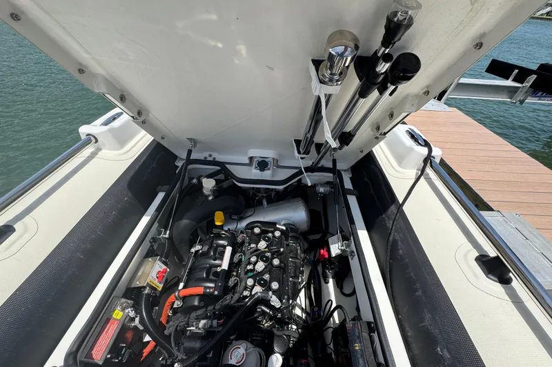 Slide: The Image of Open engine compartment of 2025 Williams Jet Tenders Sportjet 345, dockside view. - 12