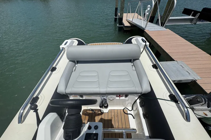 Slide: The Image of 2025 Williams Jet Tenders Sportjet 345 at dock, featuring sleek seating and controls. - 13