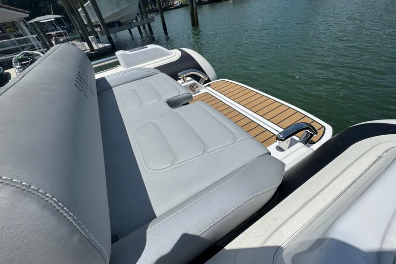 Slide: The Image of 2025 Williams Jet Tenders Sportjet 345 with sleek seating and teak deck by the water. - 6