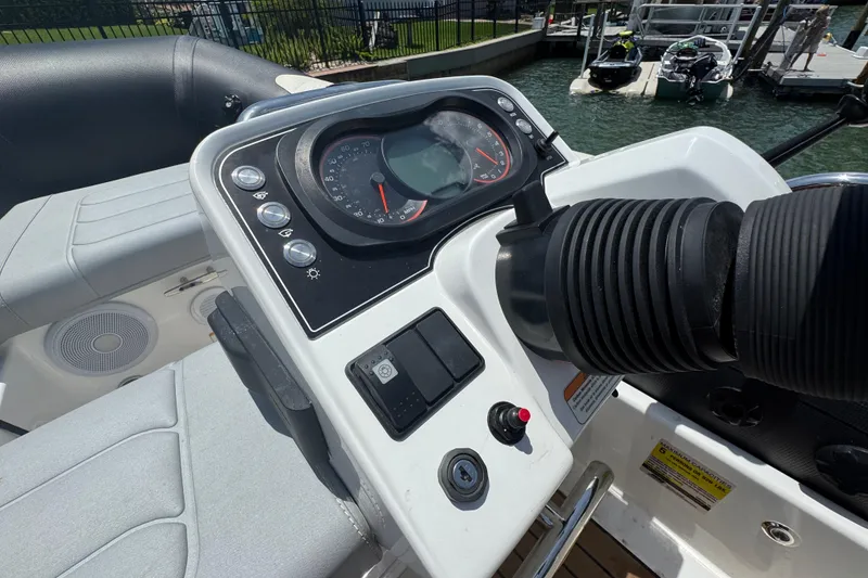 Slide: The Image of Control panel of 2025 Williams Jet Tenders Sportjet 345, docked by the water. - 9