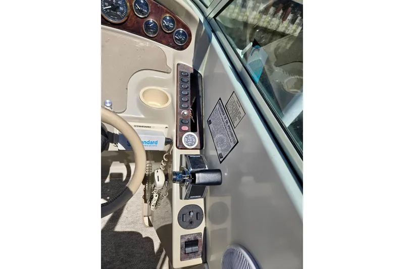 Slide: The Image of 1999 Rinker Fiesta Vee 270 boat dashboard with gauges and controls. - 11