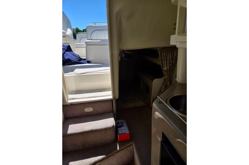 Slide: The Image of Interior view of 1999 Rinker Fiesta Vee 270 boat, showing stairs and cabin area. - 13