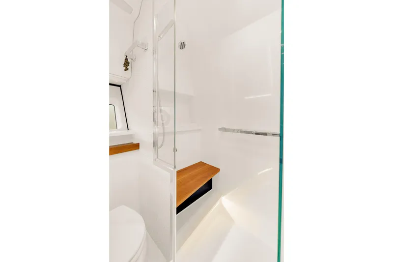 Slide: The Image of 2021 Tiara Sport 43 LE yacht bathroom with modern shower and wooden accents. - 35