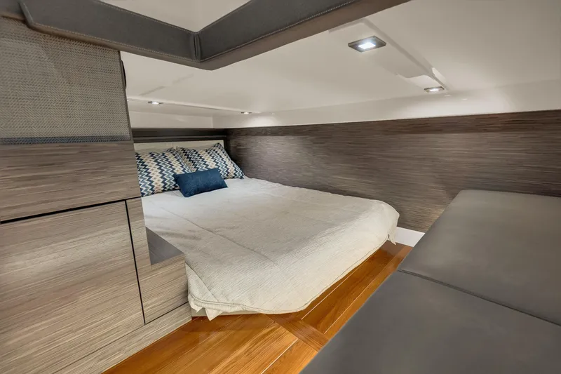 Slide: The Image of Luxurious cabin interior of 2021 Tiara Sport 43 LE yacht with modern bedding and wood accents. - 39