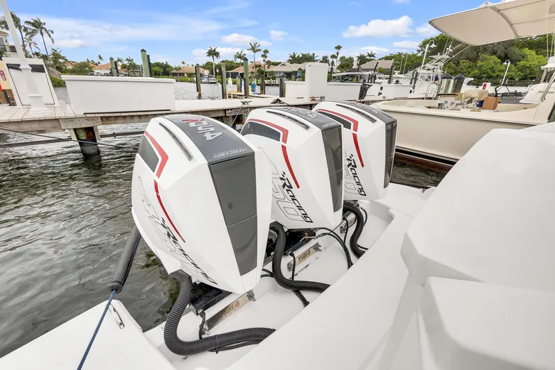 Slide: The Image of Triple Mercury Racing outboard engines on a 2021 Tiara Sport 43 LE boat at a marina. - 42