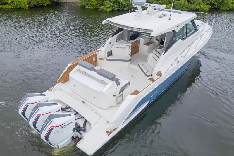 Slide: The Image of 2021 Tiara Sport 43 LE luxury boat with triple outboard engines on calm water. - 45