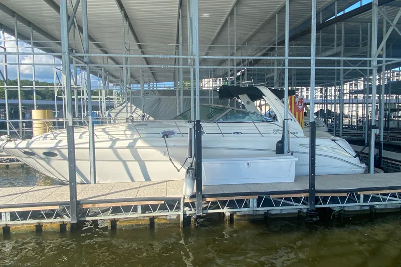 Slide: The Image of 2004 Sea Ray 380 Sundancer docked in a covered marina, side view. - 10
