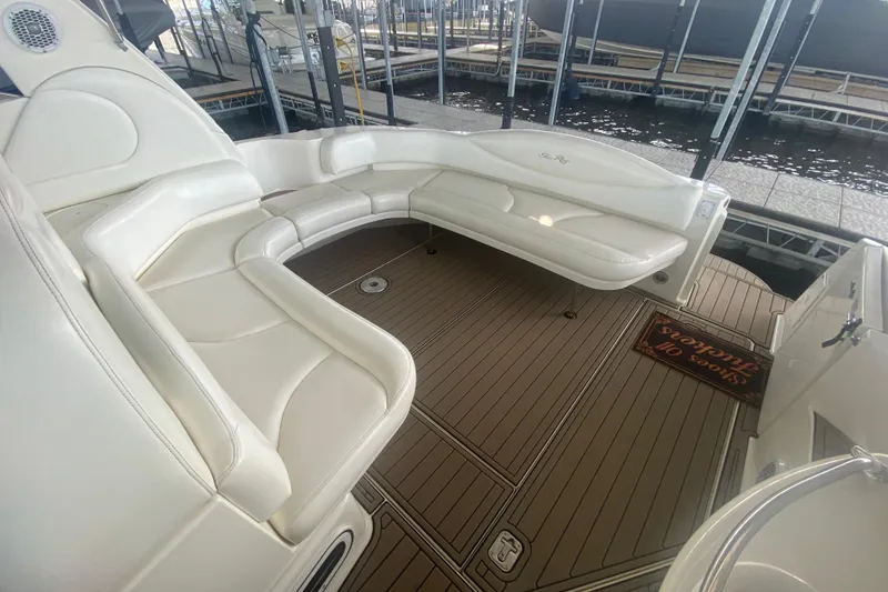 Slide: The Image of 2004 Sea Ray 380 Sundancer boat interior with white seating and wooden deck. - 16