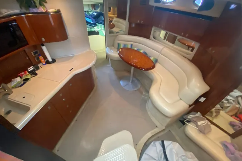 Slide: The Image of Luxurious interior of a 2004 Sea Ray 380 Sundancer yacht with kitchen and seating area. - 23