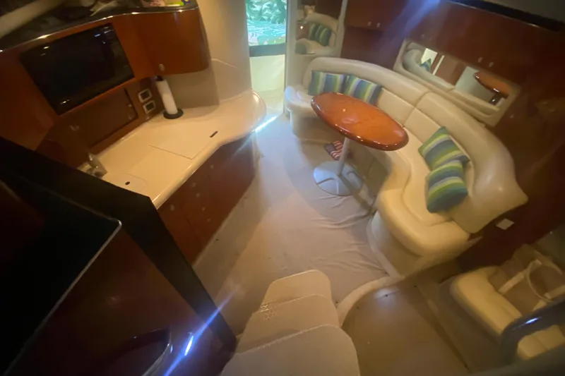 Slide: The Image of Luxurious interior of 2004 Sea Ray 380 Sundancer yacht with kitchen and seating area. - 24