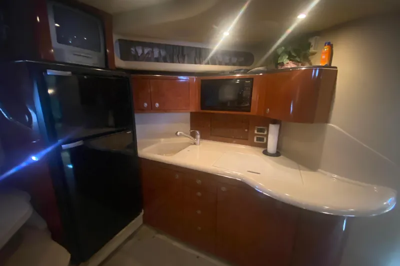 Slide: The Image of 2004 Sea Ray 380 Sundancer yacht kitchen with modern appliances and sleek cabinetry. - 25