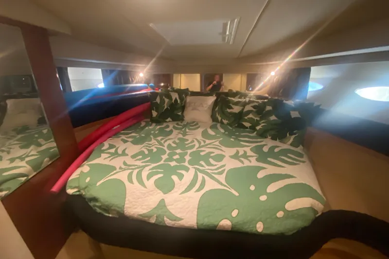 Slide: The Image of Luxurious cabin interior of 2004 Sea Ray 380 Sundancer with tropical bedding. - 29