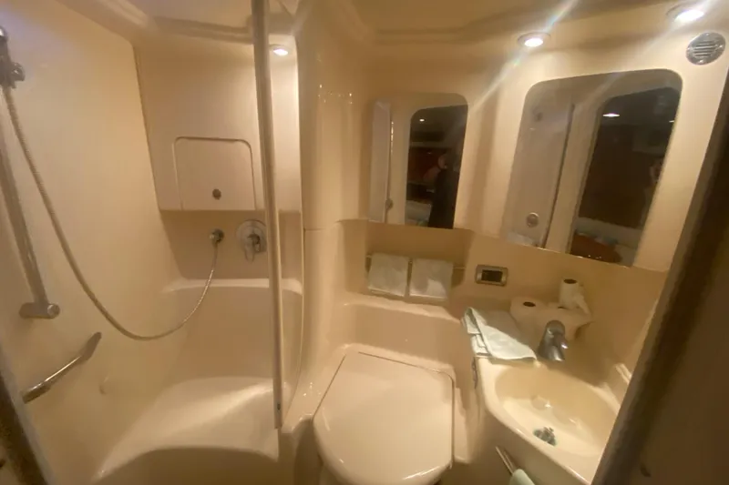 Slide: The Image of Bathroom interior of 2004 Sea Ray 380 Sundancer yacht, featuring shower and sink. - 31