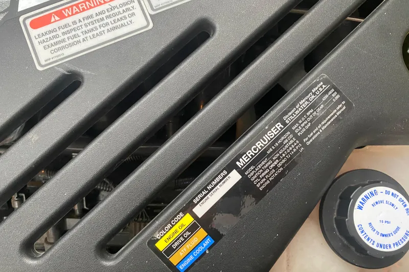Slide: The Image of Engine compartment of a 2004 Sea Ray 380 Sundancer with MerCruiser components and warning labels. - 35
