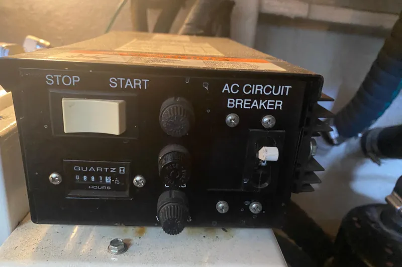 Slide: The Image of Control panel with stop/start buttons and AC circuit breaker on 2004 Sea Ray 380 Sundancer. - 37