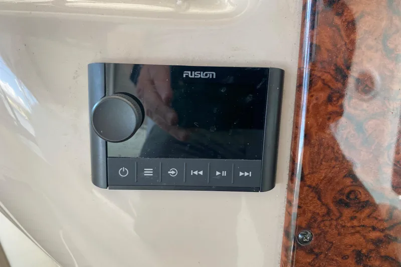 Slide: The Image of Fusion audio control panel on 2004 Sea Ray 380 Sundancer boat dashboard. - 38