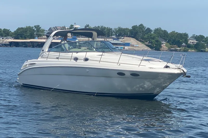 Slide: The Image of 2004 Sea Ray 380 Sundancer yacht cruising on a calm lake. - 5