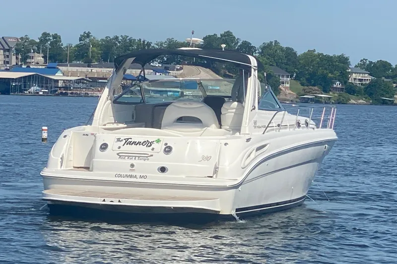 Slide: The Image of 2004 Sea Ray 380 Sundancer boat on a lake, with marina and trees in the background. - 8