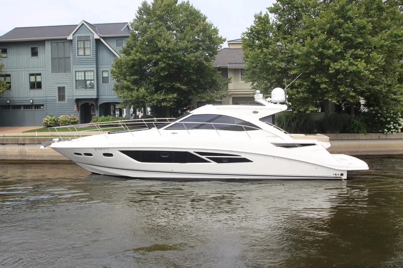 Slide: The Image of 2016 Sea Ray 510 Sundancer yacht docked near waterfront homes. - 1