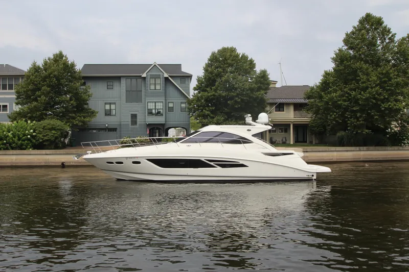 Slide: The Image of 2016 Sea Ray 510 Sundancer yacht docked near waterfront homes. - 11