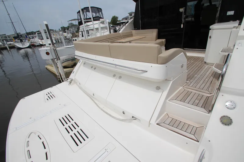 Slide: The Image of 2016 Sea Ray 510 Sundancer yacht with spacious deck and seating area in marina. - 17