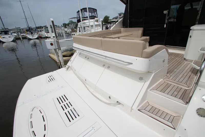 Slide: The Image of 2016 Sea Ray 510 Sundancer yacht with spacious deck and seating at marina. - 18