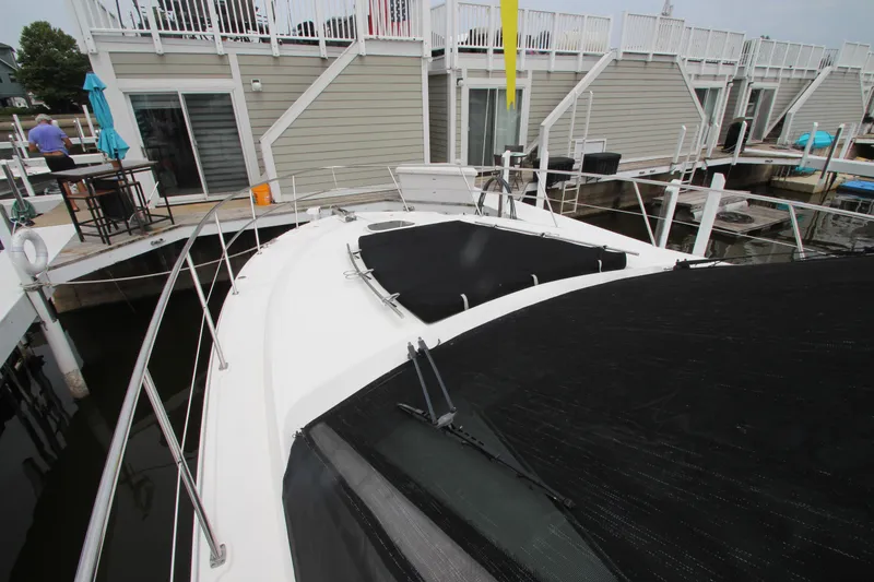 Slide: The Image of 2016 Sea Ray 510 Sundancer yacht docked at marina, featuring spacious deck and modern design. - 27