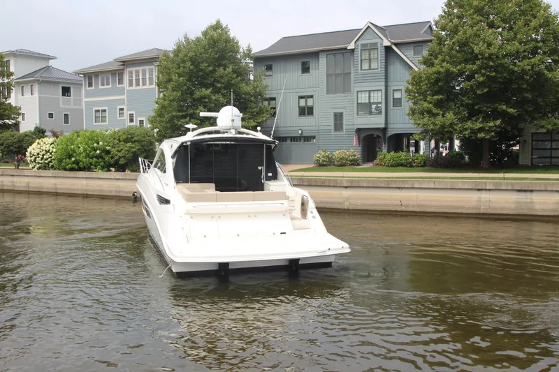 Slide: The Image of 2016 Sea Ray 510 Sundancer yacht cruising near waterfront homes. - 3