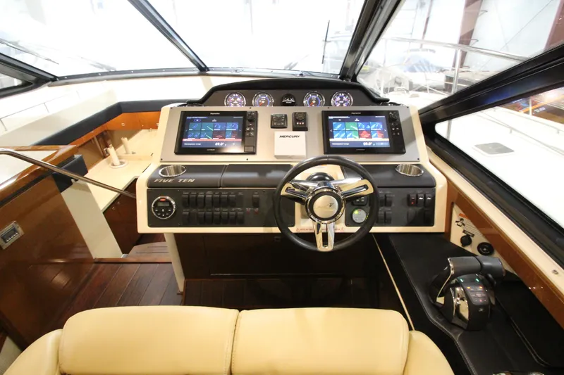 Slide: The Image of 2016 Sea Ray 510 Sundancer helm with dual displays and modern controls. - 31