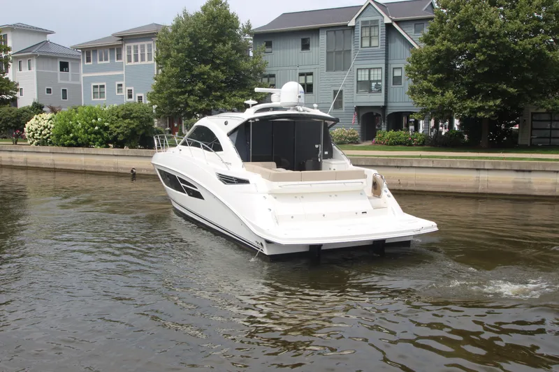 Slide: The Image of 2016 Sea Ray 510 Sundancer yacht cruising near waterfront homes. - 4