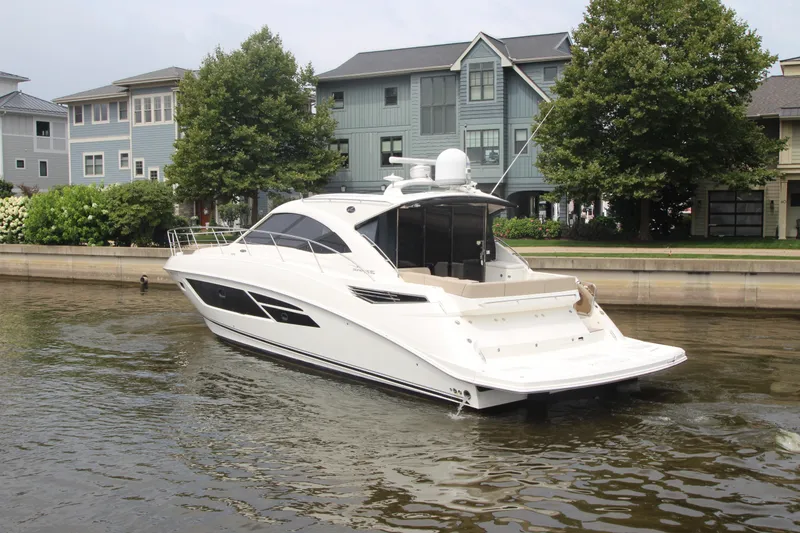 Slide: The Image of 2016 Sea Ray 510 Sundancer yacht docked near waterfront homes. - 5