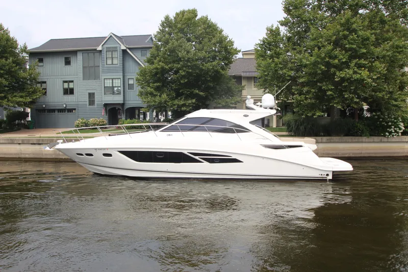 Slide: The Image of 2016 Sea Ray 510 Sundancer yacht docked by waterfront homes. - 6