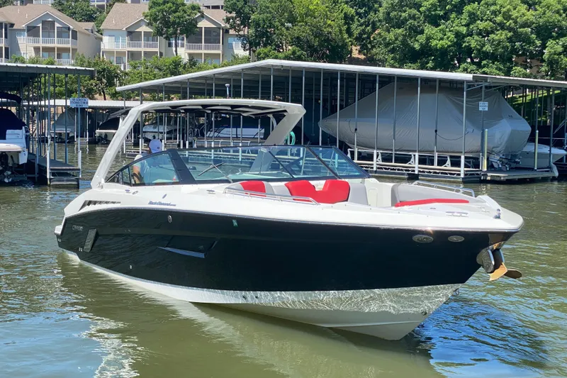 The Image of 2014 Cruisers Sport Series 328 Black Diamond boat docked on a sunny day. - 0