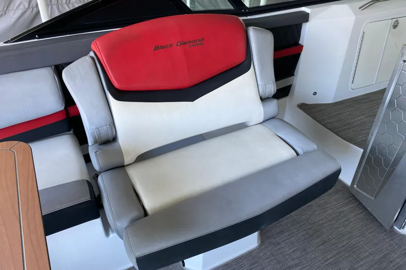 Slide: The Image of 2014 Cruisers 328 Black Diamond boat seat with red and gray upholstery. - 18