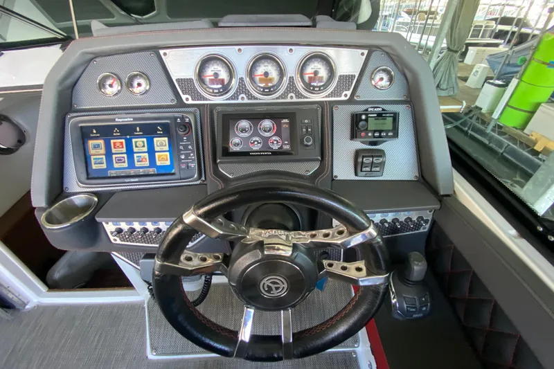 Slide: The Image of Dashboard of 2014 Cruisers 328 Black Diamond boat with advanced controls and gauges. - 21