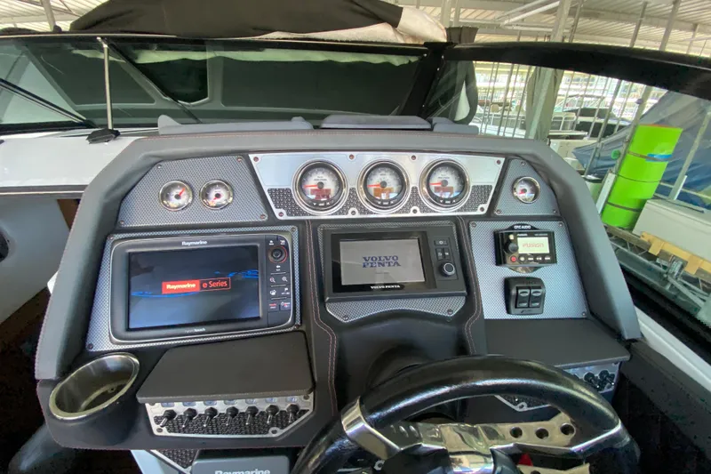 Slide: The Image of Dashboard of 2014 Cruisers 328 Black Diamond boat with navigation and control systems. - 22