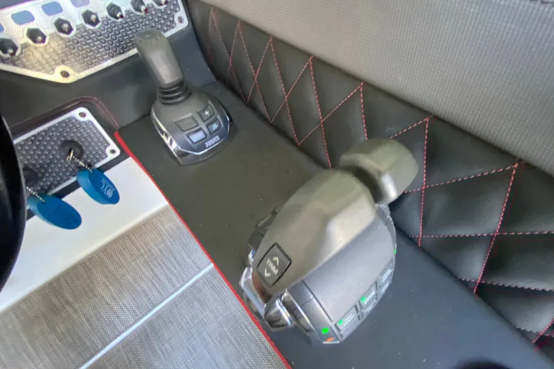Slide: The Image of Control panel of 2014 Cruisers 328 Black Diamond boat with joystick and throttle. - 23