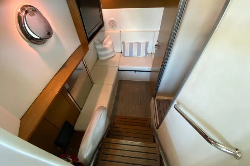 Slide: The Image of Interior of 2014 Cruisers 328 Black Diamond yacht with cozy seating area. - 29