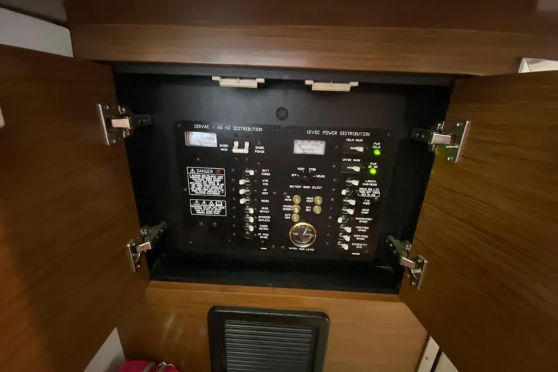 Slide: The Image of Electrical panel inside 2014 Cruisers 328 Black Diamond boat, showcasing power distribution controls. - 31